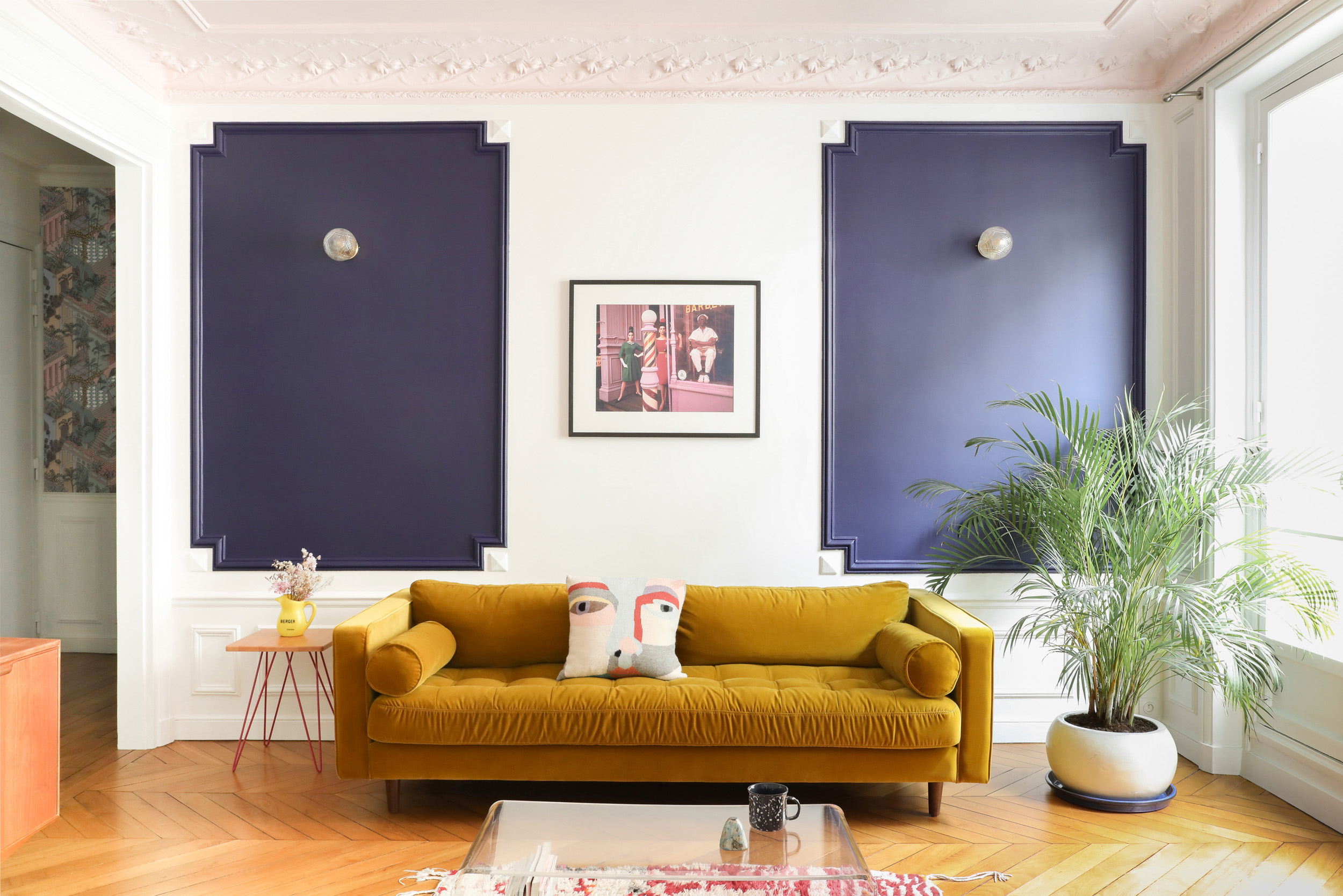 white living room with navy panelling and mustard sofa